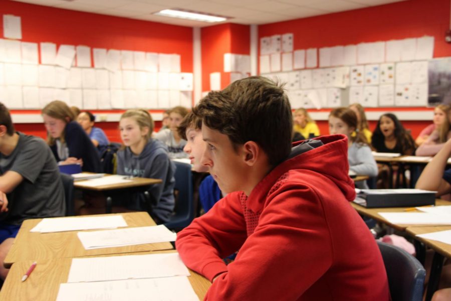 A freshman student listens to English teacher Todd Smith in ELA 9.