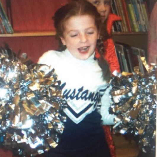 Senior, Emma Brunner, dressed as a Mustang cheerleader.