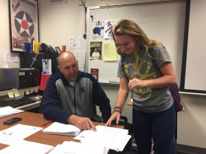 Sophomore, Emily Grice and Mr. Doll discuss the future plans of the Young Republicans Club during north time.