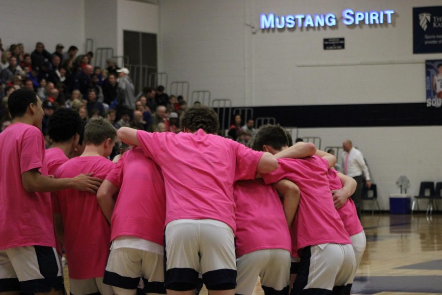 The Mustangs huddle up before the game starts. 