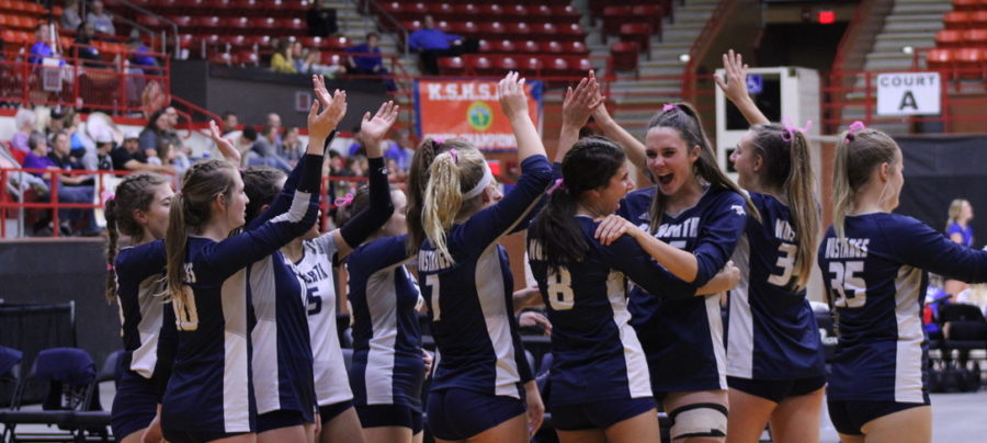 Volleyball celebrates their victory over Olathe Northwest in the semifinals.